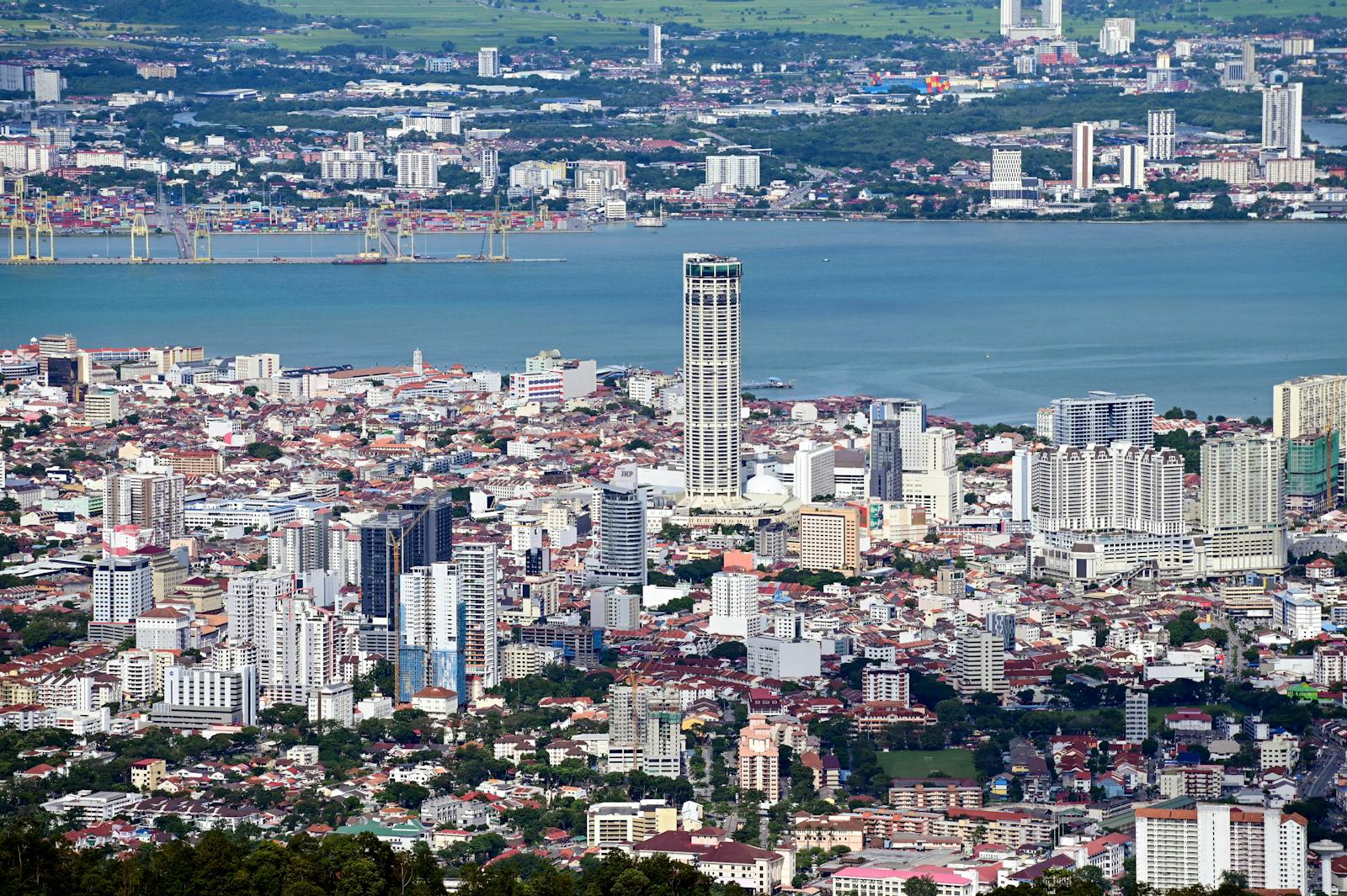 A stunning aerial view of George Town, Penang showcasing the urban landscape and coastal beauty.