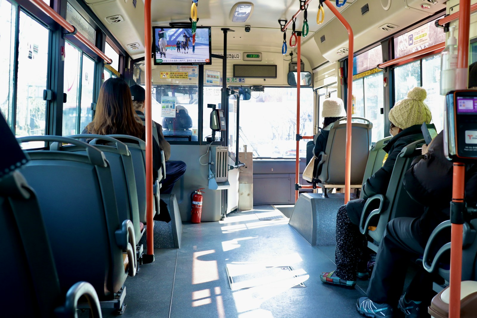 a group of people sitting on a bus next to each other