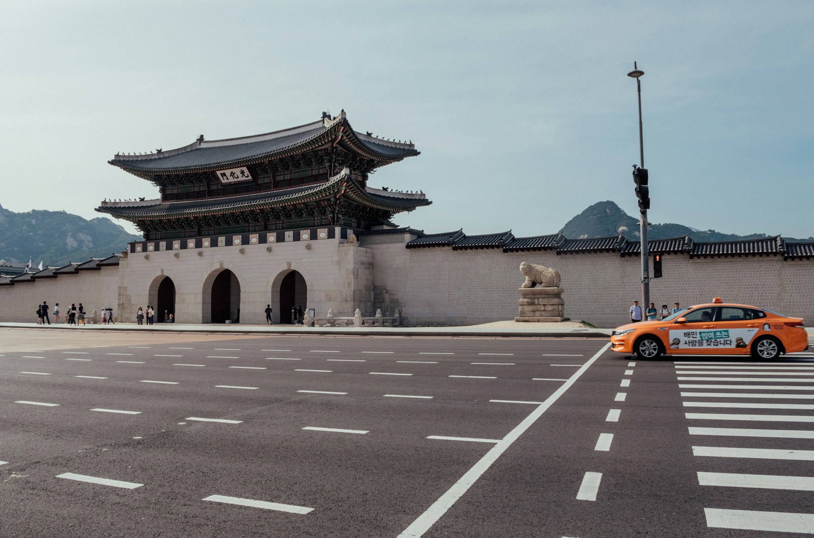 orange vehicle on street during daytime